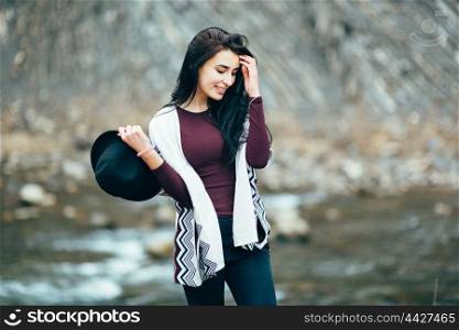 girl in warm sweaters walking along a mountain river, love story