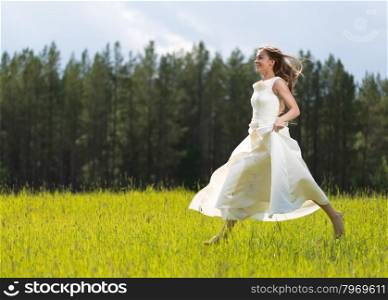 girl in white dress jumping in a field