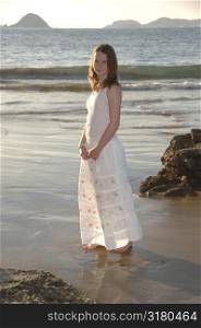 Girl in white dress on the beach