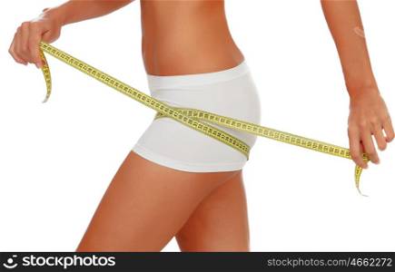 Girl in white underwear with a tape measure around her thigh isolated