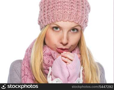 Girl in winter clothes warming hands