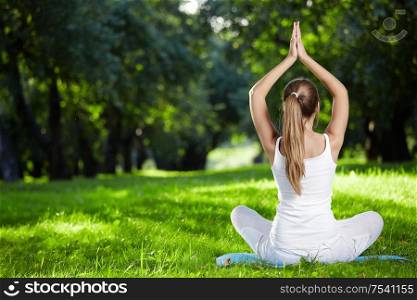 Girl in yoga pose in the park