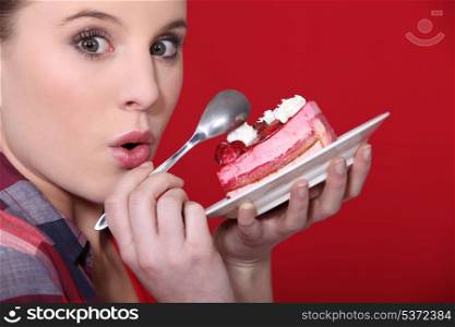 girl indulging in a piece of delicious strawberry cake