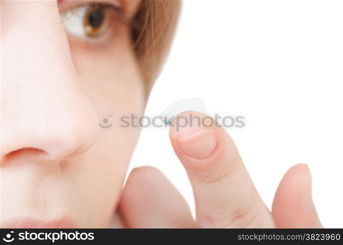 girl inserts corrective lens in eye close up