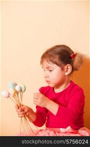 Girl is doing an Easter handmade decorations for holiday. Girls on an Easter Egg hunt