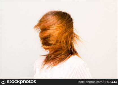 Girl is rotating Red Hair. Young beautiful girl with red hair flying