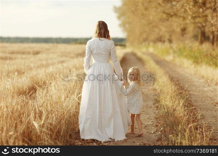 girl is with her mother in the autumn field