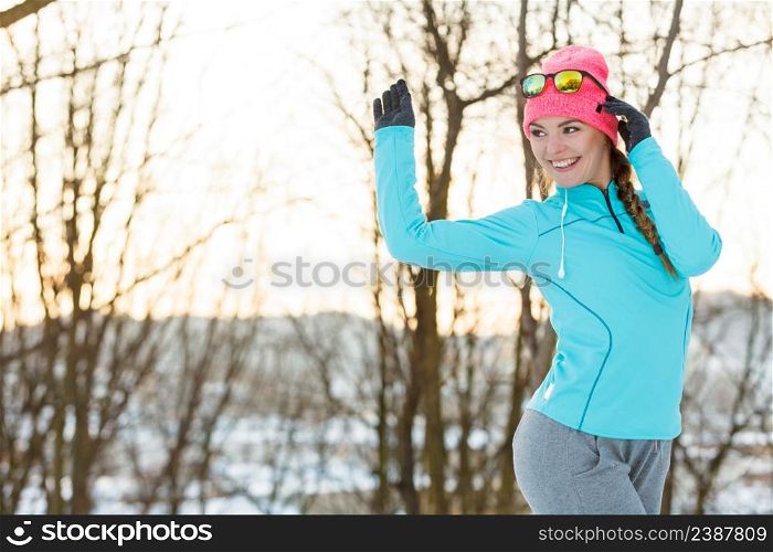 Girl jogging in snow park. Staying fit and safe during winter. Nature fitness health safety health concept. . Girl jogging in winter park