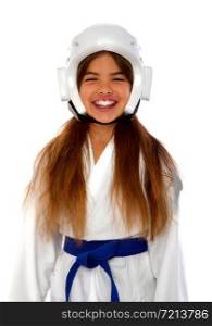 girl karateka in a protective helmet a blue belt and a white kimono with a mouth guard smiling prepares for training. Karate Girl Uniform