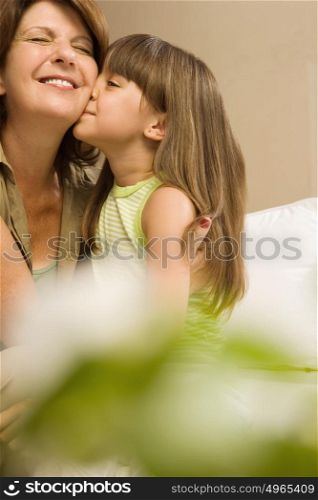 Girl kissing grandmother
