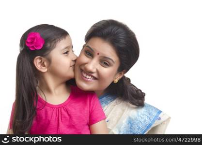 Girl kissing her mother on the cheek