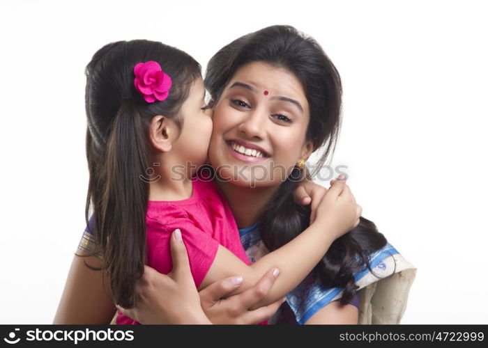 Girl kissing her mother on the cheek