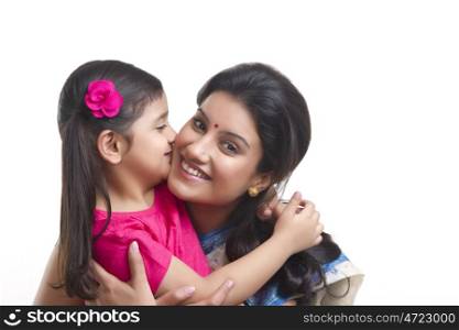 Girl kissing her mother on the cheek