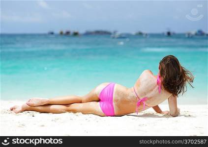Girl laying on a tropical beach