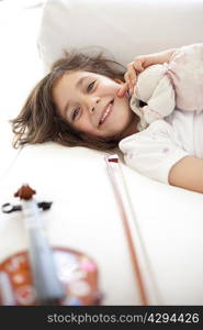 Girl laying on couch with violin