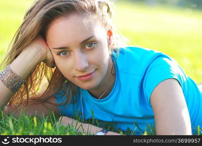 Girl laying on fresh green grass