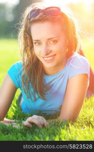 Girl laying on fresh green grass