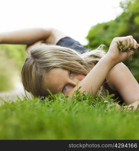 Girl laying on grass in dirt path
