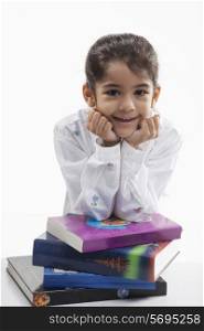 Girl leaning on a stack of books
