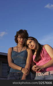Girl leaning on a teenage girl&acute;s shoulder