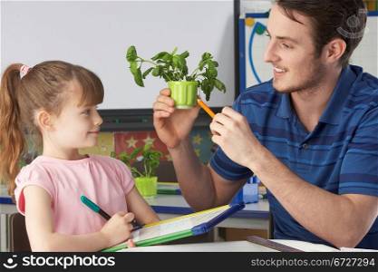 Girl learning about plants with teacher