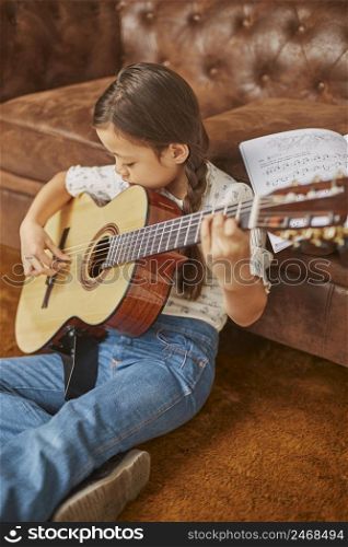 girl learning how play guitar home 2