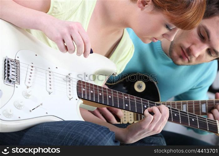 Girl learning to play guitar