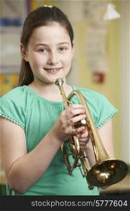 Girl Learning To Play Trumpet In School Music Lesson
