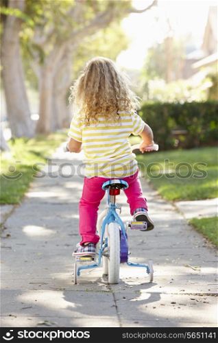 Girl Learning To Ride Bike On Path