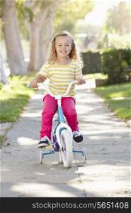 Girl Learning To Ride Bike On Path