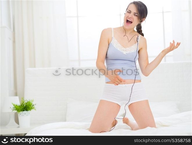 Girl listening rock music in bedroom