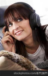 girl listening to music looking happy at home
