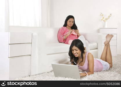 Girl listening to music on laptop