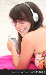 Girl listening to music on the beach