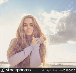Girl looking at camera. Portrait of happy young female against clear sky