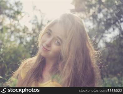 Girl looking at camera. Pretty blonde outdoors. Colorized image