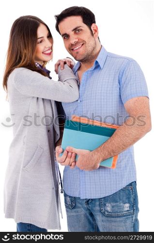 Girl looking at her boyfriend by her hands on his shoulders on a white background