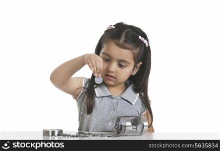 Girl looking at Indian coin against white background