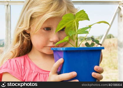 Girl looking at plant