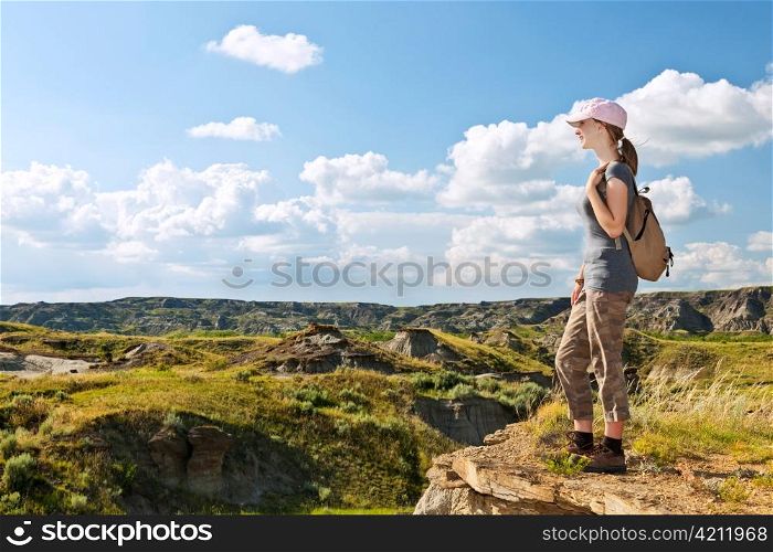 Girl looking at scenic view of the Badlands in Dinosaur provincial park, Alberta, Canada