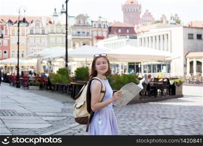 girl looking at the map standing at the main square Rynek of polish city Poznan