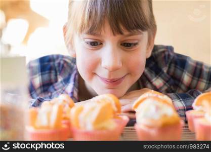 Girl Looking Hungrily At Home Made Cup Cakes