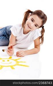Girl lying on floor and painting a happy sun
