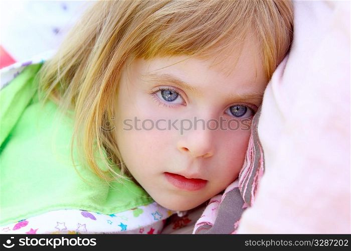 girl lying on pillow beautiful blue eyes toddler looking camera