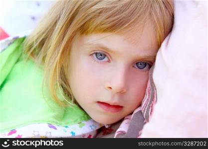 girl lying on pillow beautiful blue eyes toddler looking camera