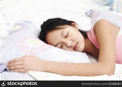 Girl lying on the bed with her eyes closed