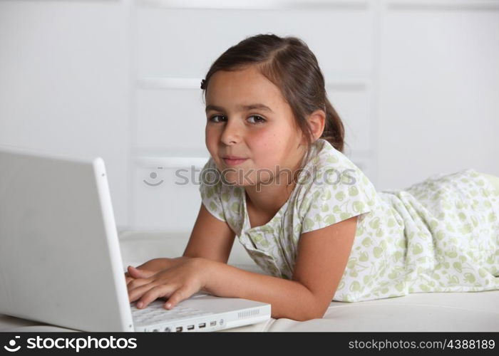 Girl lying with computer