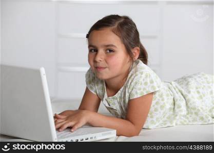 Girl lying with computer