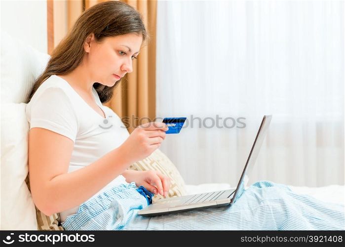 girl makes purchases from the online store paying card