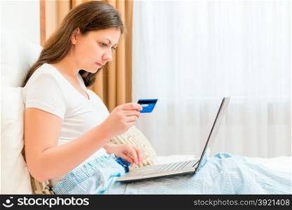 girl makes purchases from the online store paying card